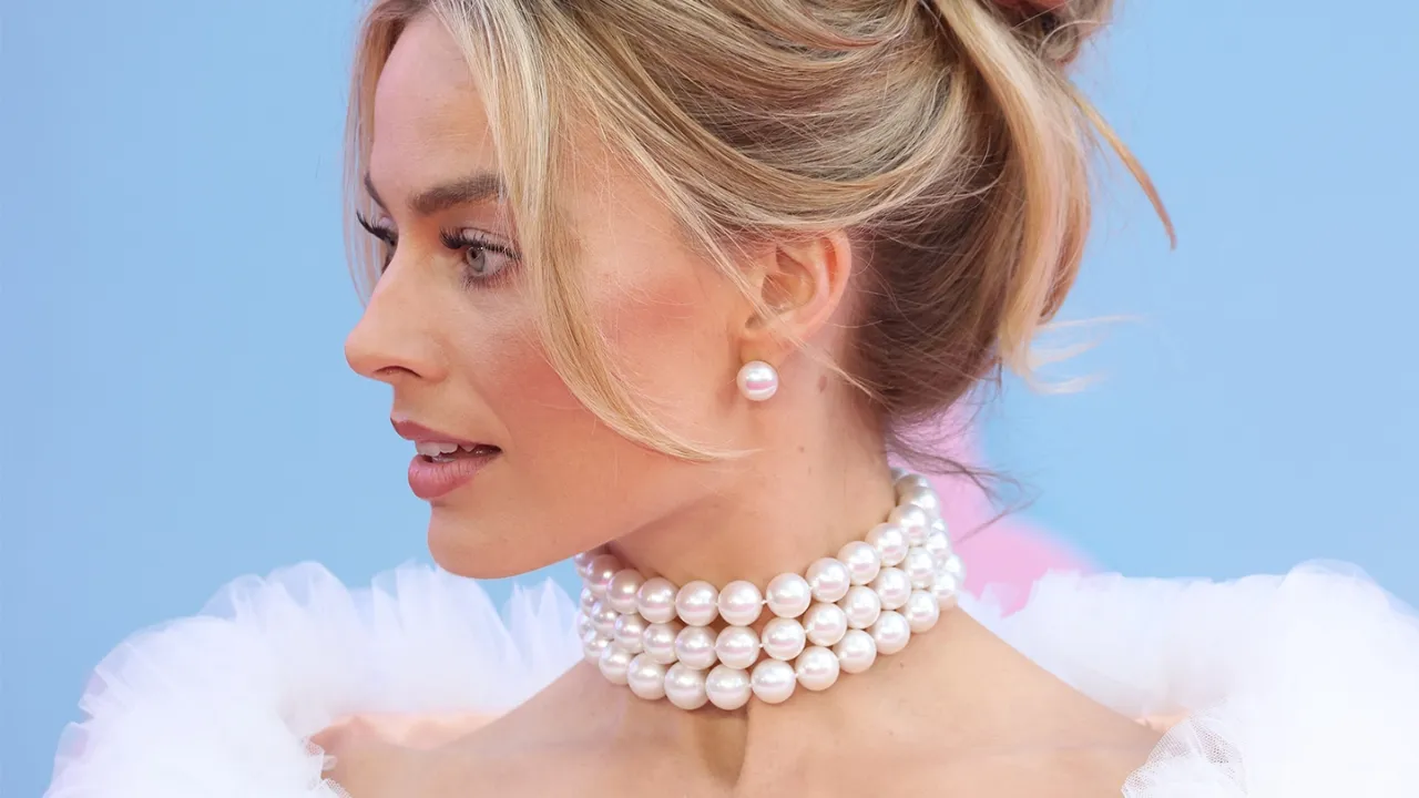 Margot Robbie wearing a triple strand white South Sea pearl necklace and stud earrings