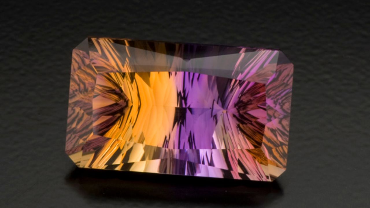 Concave facets on the pavilion contribute to the striking look of this 27.50-ct. ametrine. Creative gem cutters sometimes use concave facets to give a gem a dramatic appearance. Photo by Robert Weldon/GIA, courtesy Minerales y Metales del Oriente.