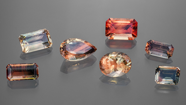 Figure 1. Faceted Oregon sunstone crystals (2.75–7.71 ct) representing the variety of colors observed. Photo by Adriana Robinson. Courtesy of the GIA Museum. Gifts of Western Ventures (pear shape), Dust Devil Mining Co. (oval), and John and Laura Ramsey (emerald cut on the far right).