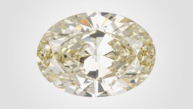 Figure 1. This 3.07 ct HPHT-treated CVD-grown diamond received a color grade of brownish greenish yellow, with the causes of color including isolated nitrogen and SiV– centers. Photo by Diego Sanchez.