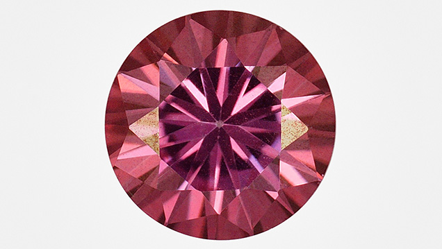 Synthetic moissanite coated with a thin colored film Synthetic moissanite coated with a thin colored film