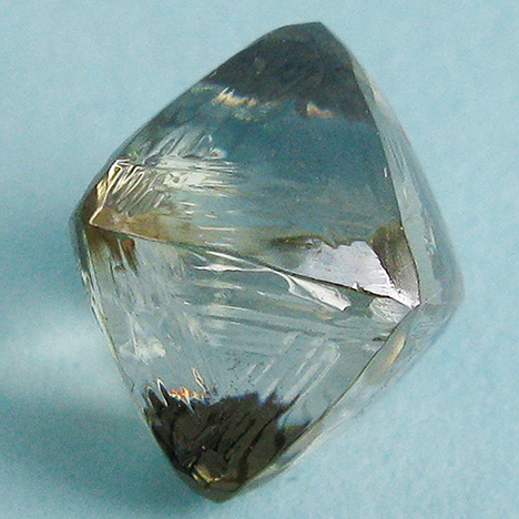 Synthetic moissanite coated with a diamond film Synthetic moissanite coated with a diamond film
