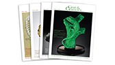A collection of magazine covers featuring a green snake sculpture and various artistic designs.