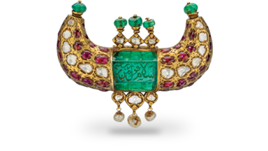 This gold pendant features a 125 carat Colombian emerald engraved in Arabic with salutations of peace. Set with diamonds, Burmese rubies, emerald beads and dangling pearls, it was made for a ruler of the Kingdom of Mysore. Mughal Era • Mysore • 18th century • emerald, ruby, diamond and pearl in 22K gold • 6 x 8.5 x 2 cm