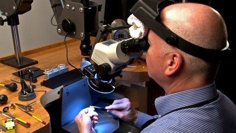 Jeweler working with various platinum tools at the bench Jeweler working with various platinum tools at the bench