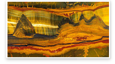 Close up view of a large, polished slab of quartz variety Tiger’s Eye from the Marra Mamba region of Western Australia. It measures at 10 feet long, 20 inches wide and 2 inches thick. Photo: Emily Lane/GIA